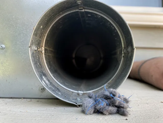 West Puente Valley Dryer Vent Cleaning technician using specialized equipment to clear severe dryer vent blockage in West Puente Valley